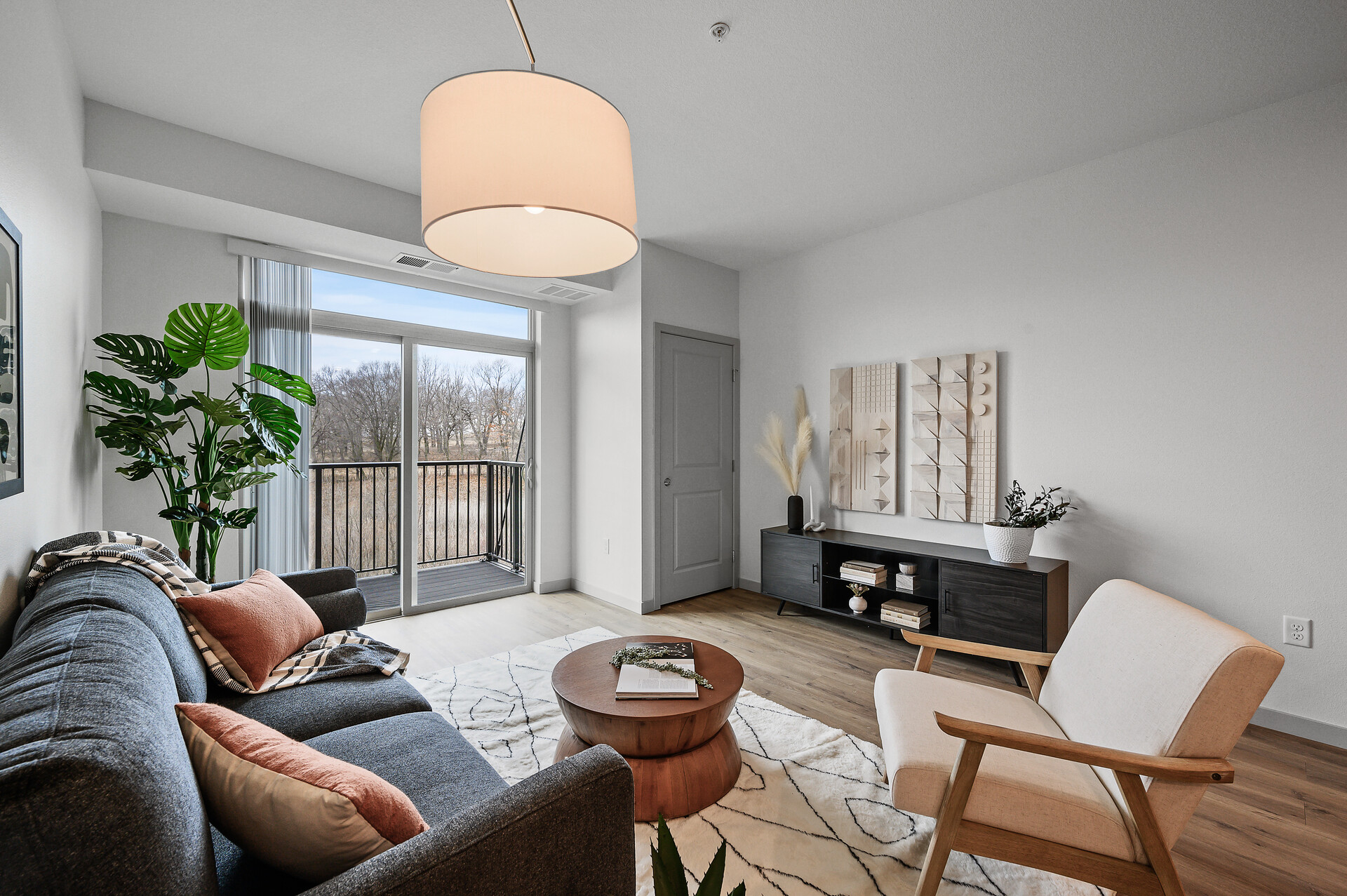 Modern living room with plush seating and blue accent lighting.